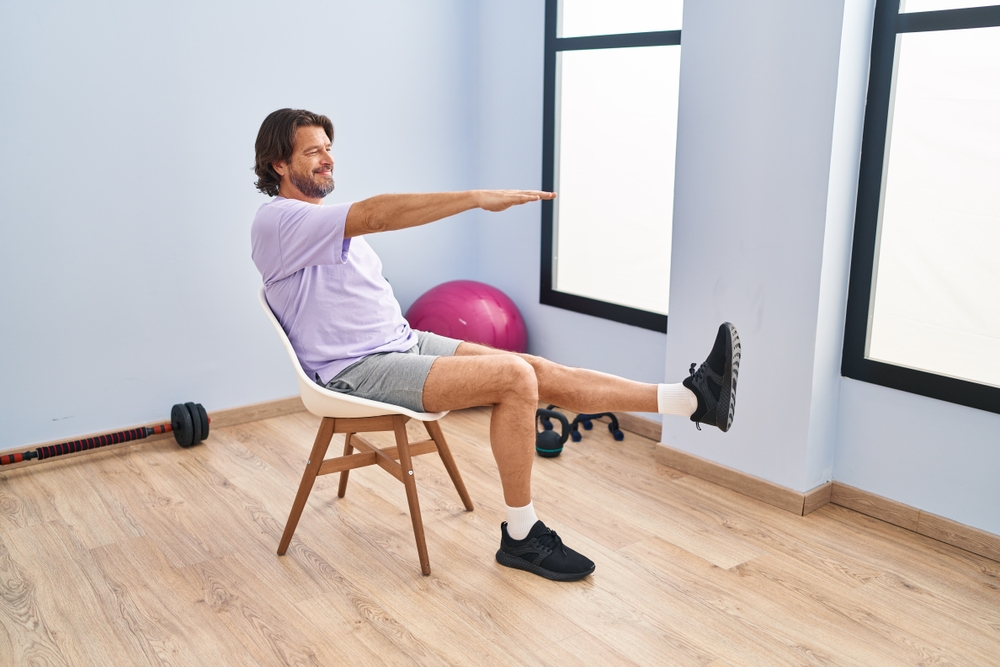 Man practicing chair yoga