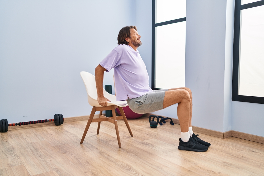 Man practicing chair yoga